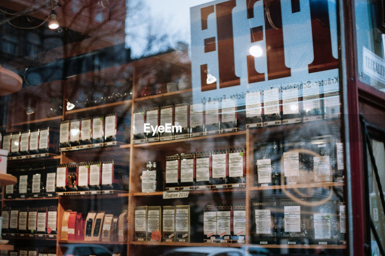 REFLECTION OF BUILDING IN GLASS WINDOW