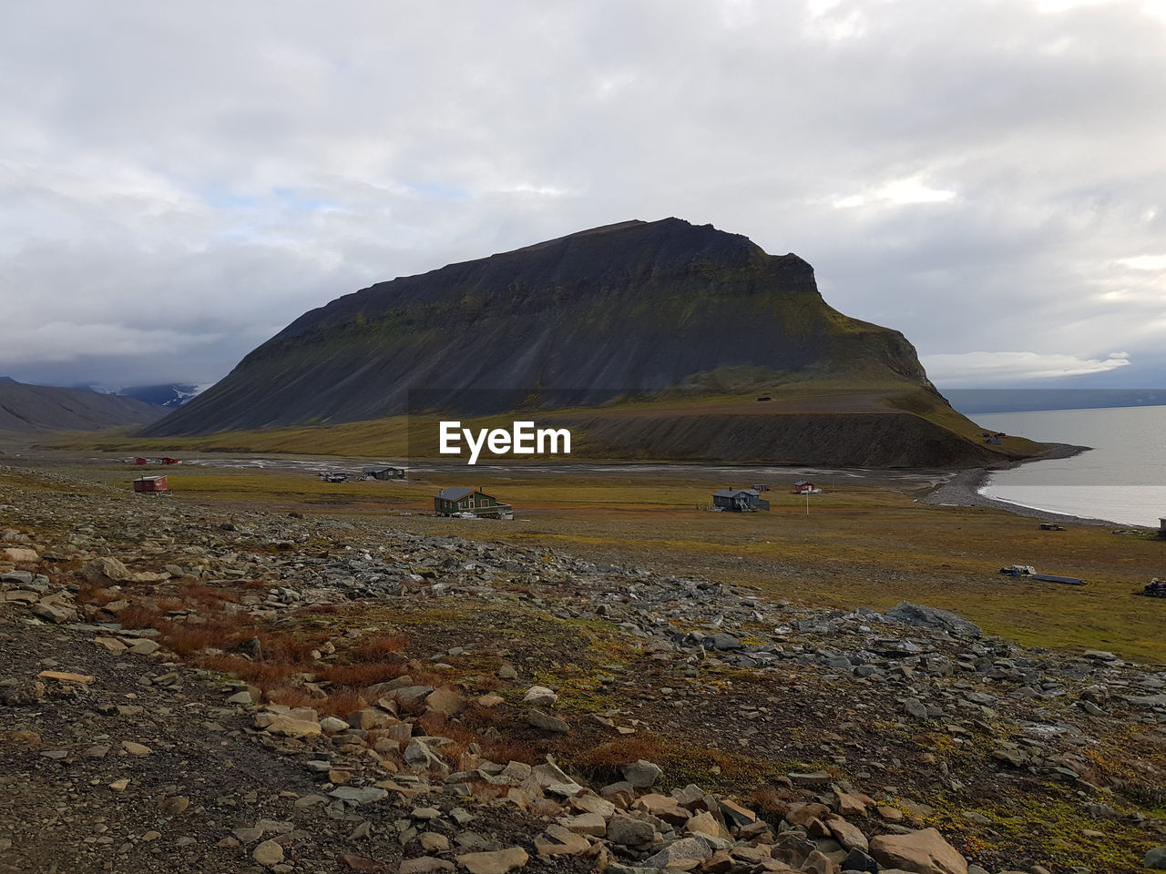 Scenic view of sea and mountains against sky