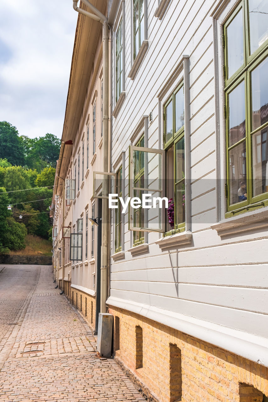 Apartment building on a street with open windows