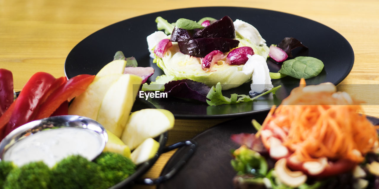 Close-up of various food served in plates on table