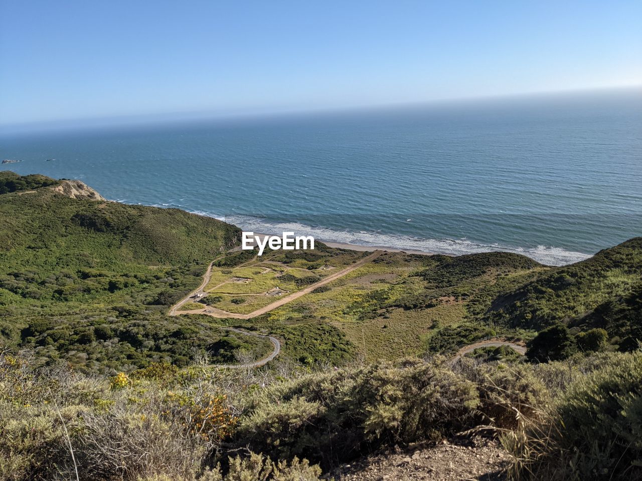 HIGH ANGLE VIEW OF SEA AND ROAD AGAINST SKY