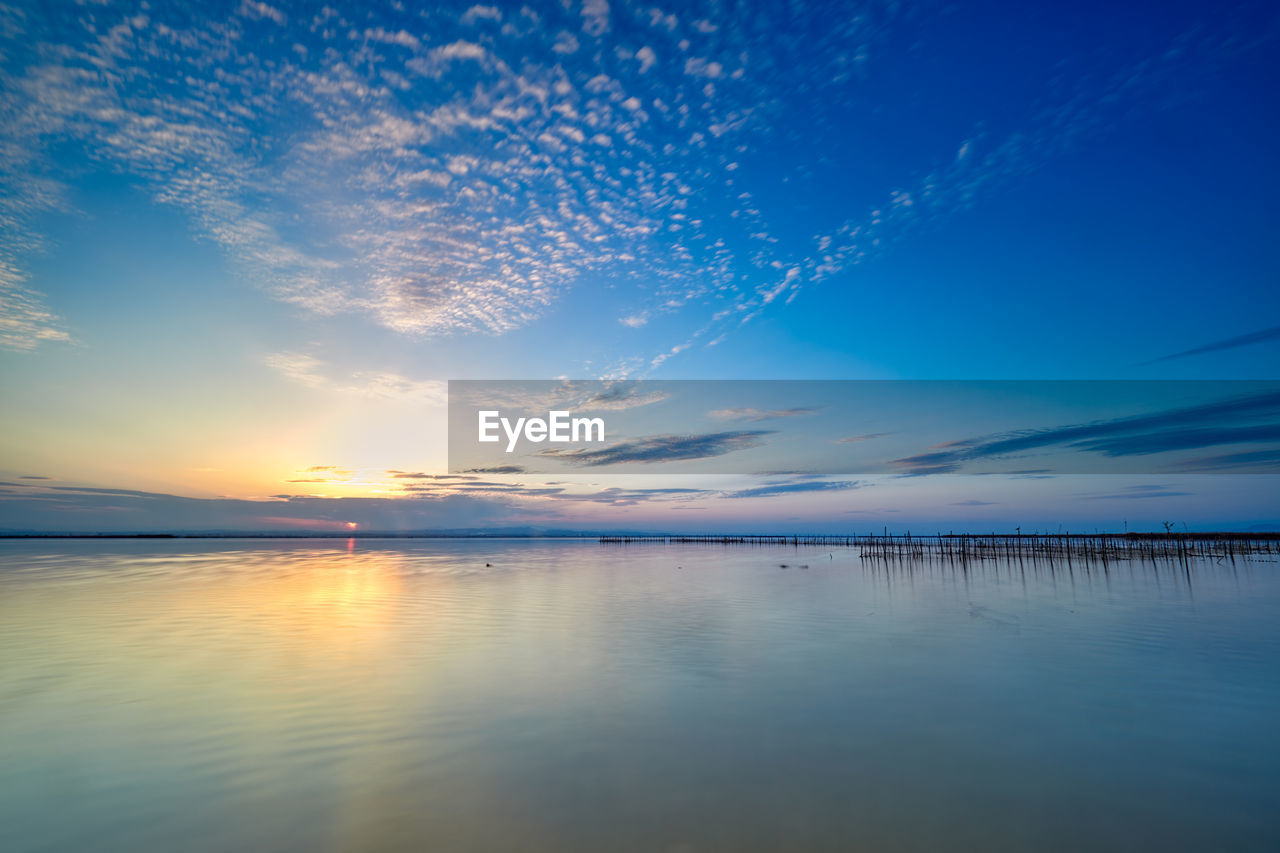 Scenic view of sea against sky at sunset