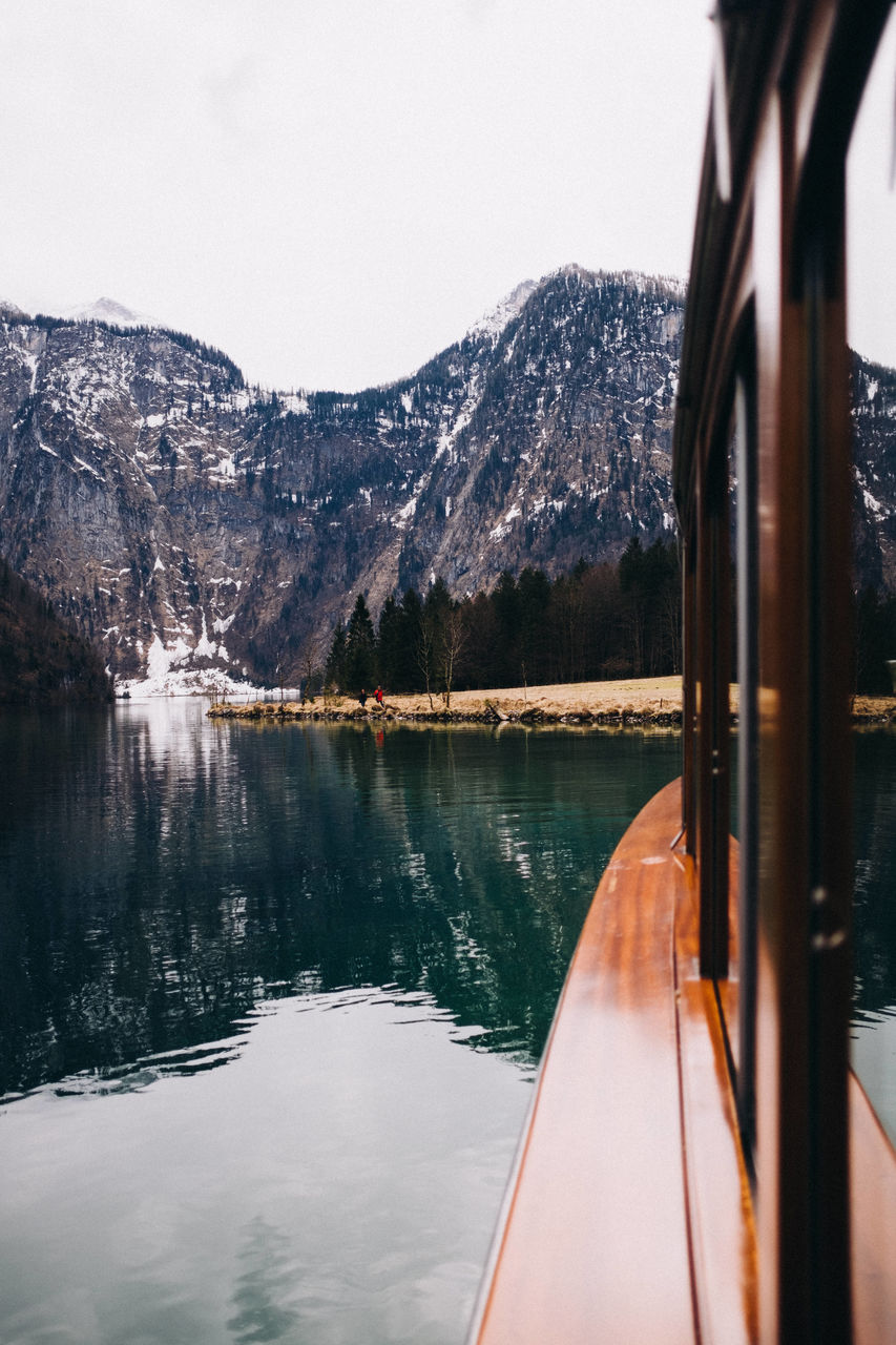 Reflection of trees in lake against clear sky