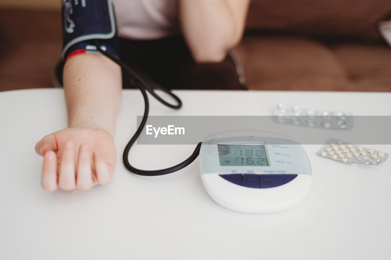 indoors, hand, one person, technology, adult, communication, finger, close-up, table, wireless technology, computer, healthcare and medicine, glasses, business