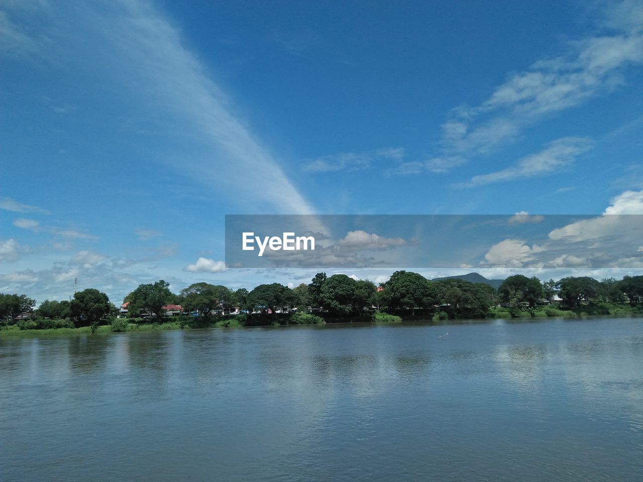 Scenic view of lake against blue sky