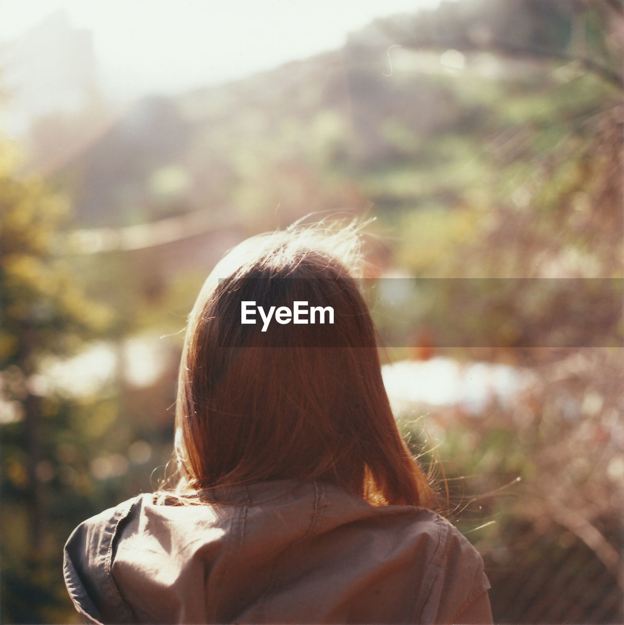 Rear view of woman with brown hair during sunny day