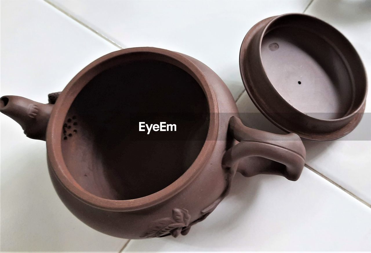 cup, brown, coffee cup, ceramic, kitchen utensil, indoors, no people, household equipment, cookware and bakeware, iron, tableware, food and drink, cooking pan, teapot