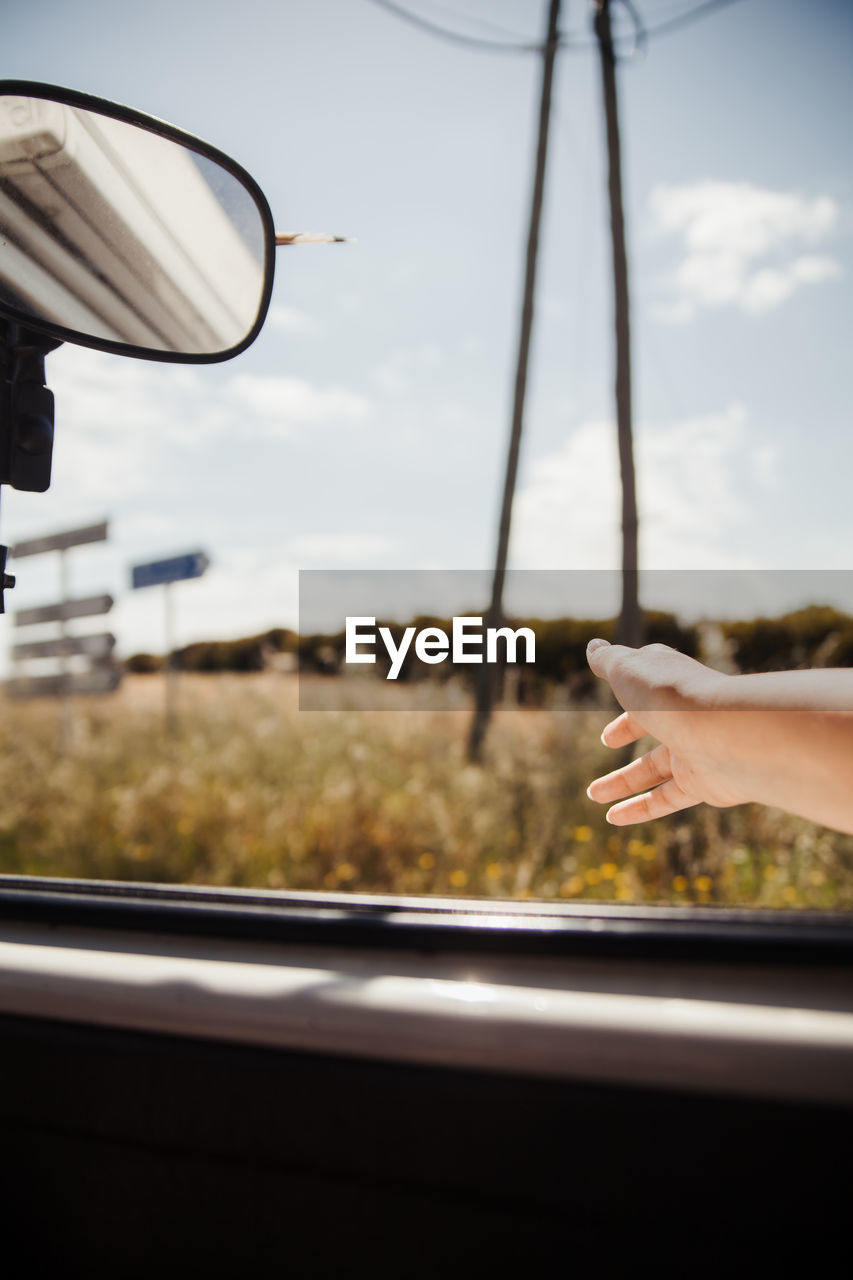 Cropped hand of person gesturing in convertible