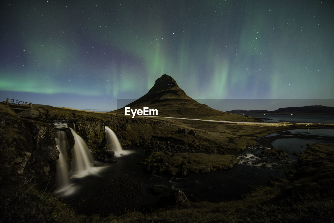 Scenic view of landscape against sky at night