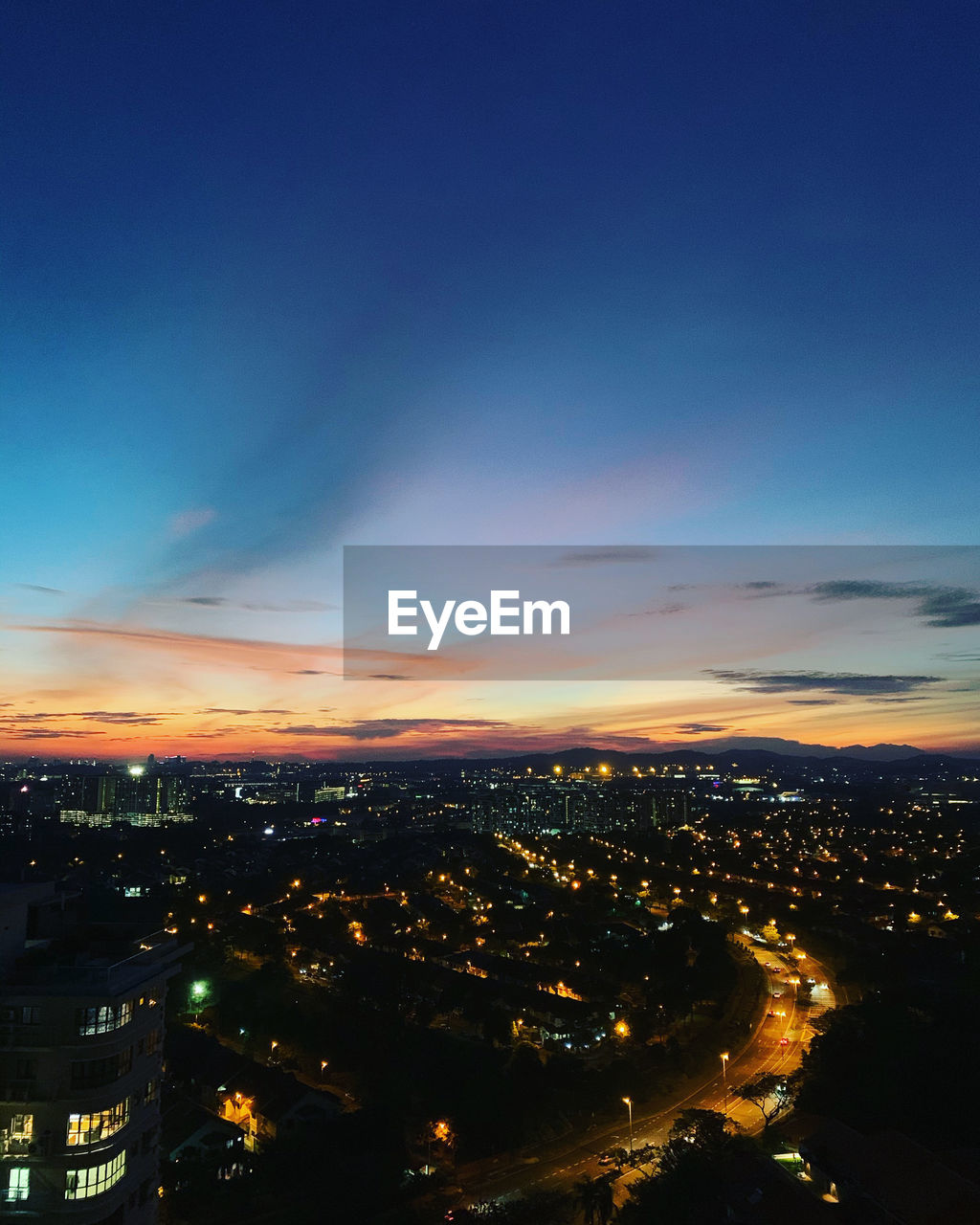 High angle view of illuminated city against sky at night