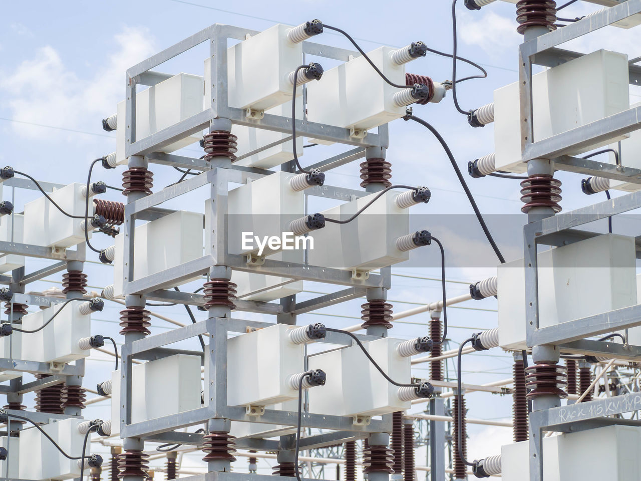 LOW ANGLE VIEW OF ELECTRICITY PYLON HANGING ON POLE