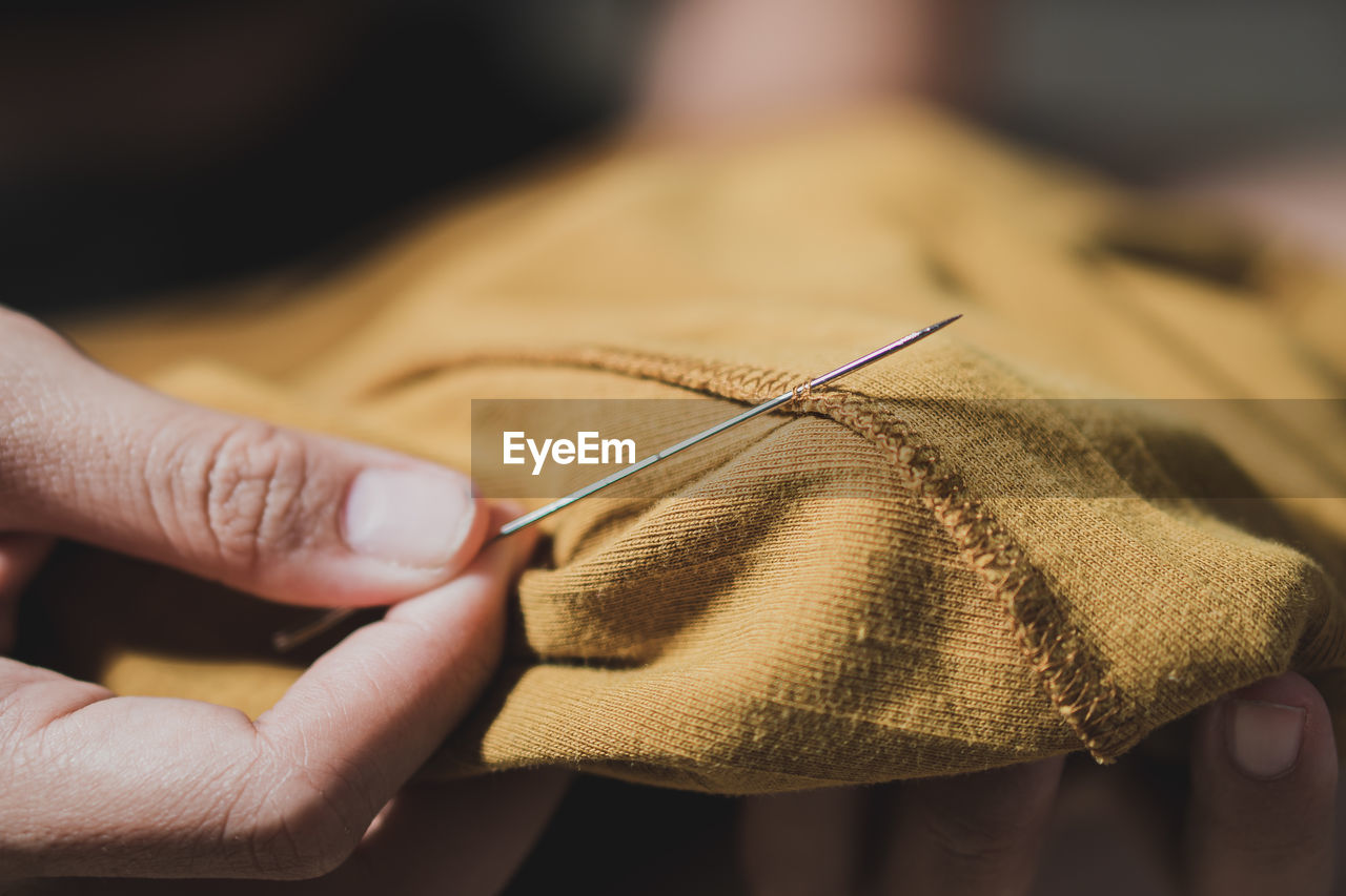 hand, one person, close-up, textile, adult, art, sewing, holding, wool, skill, craft, knitting needle, indoors, knitting, focus on foreground, thread, clothing, yellow, working, occupation, creativity, sewing needle, women, material