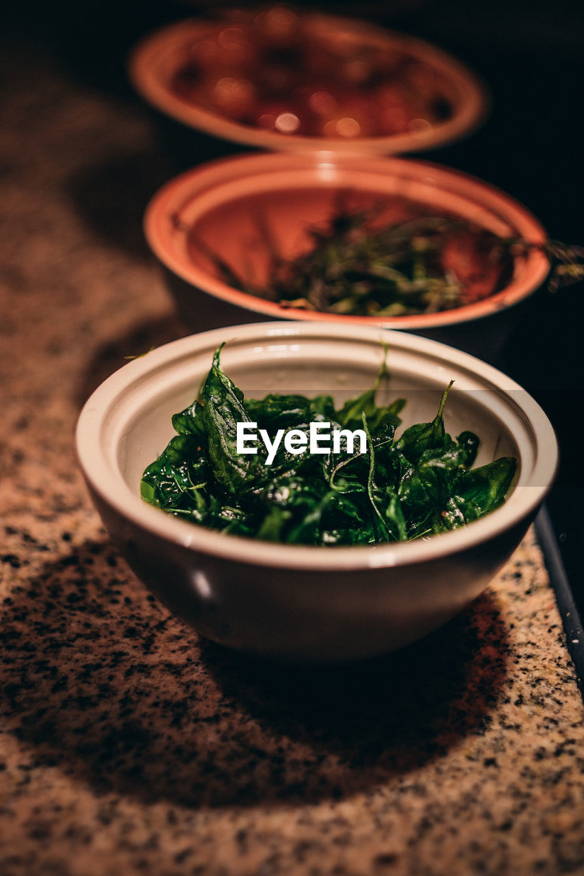 High angle view of vegetables in bowls on floor