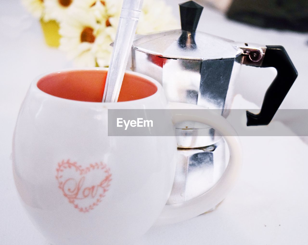 Close-up of cup nect to flower pot