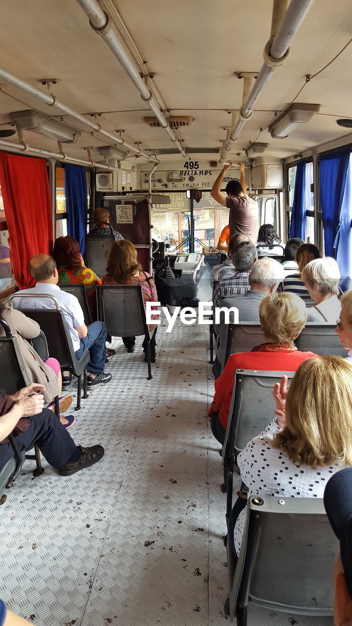 PEOPLE SITTING IN BUS