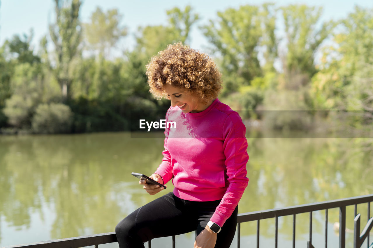 Athlete woman using her smartphone