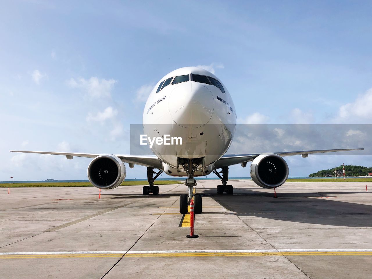 Airplane at runway against sky