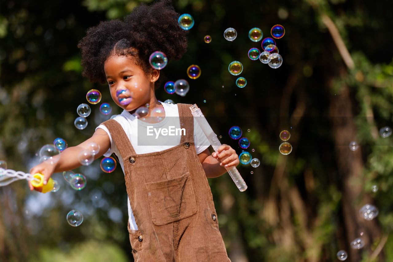 Full length of a girl with bubbles