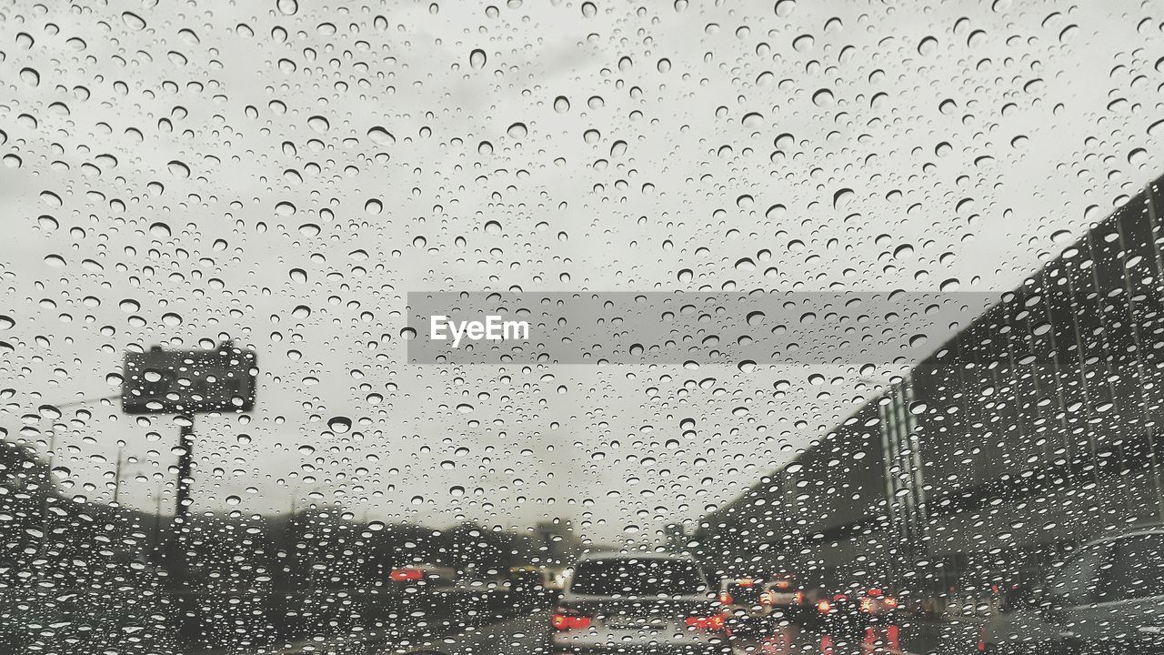 Close-up of wet car windshield during rainy season