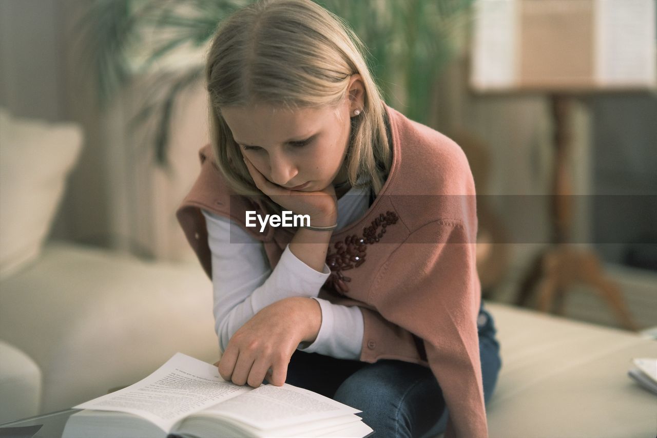 Midsection of woman reading book