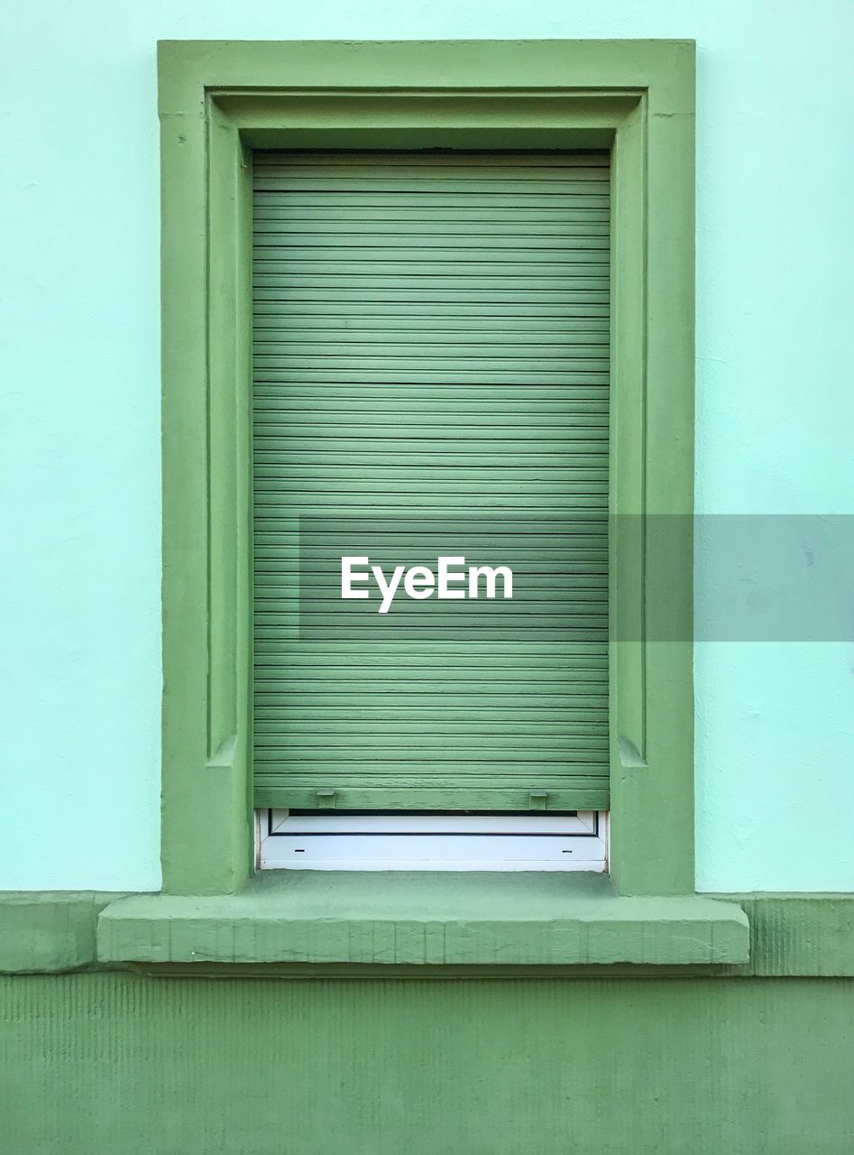 Closed window of green building