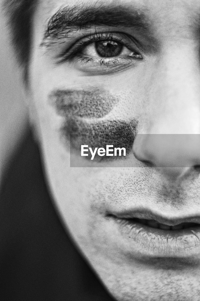 Close-up portrait of man with face paint