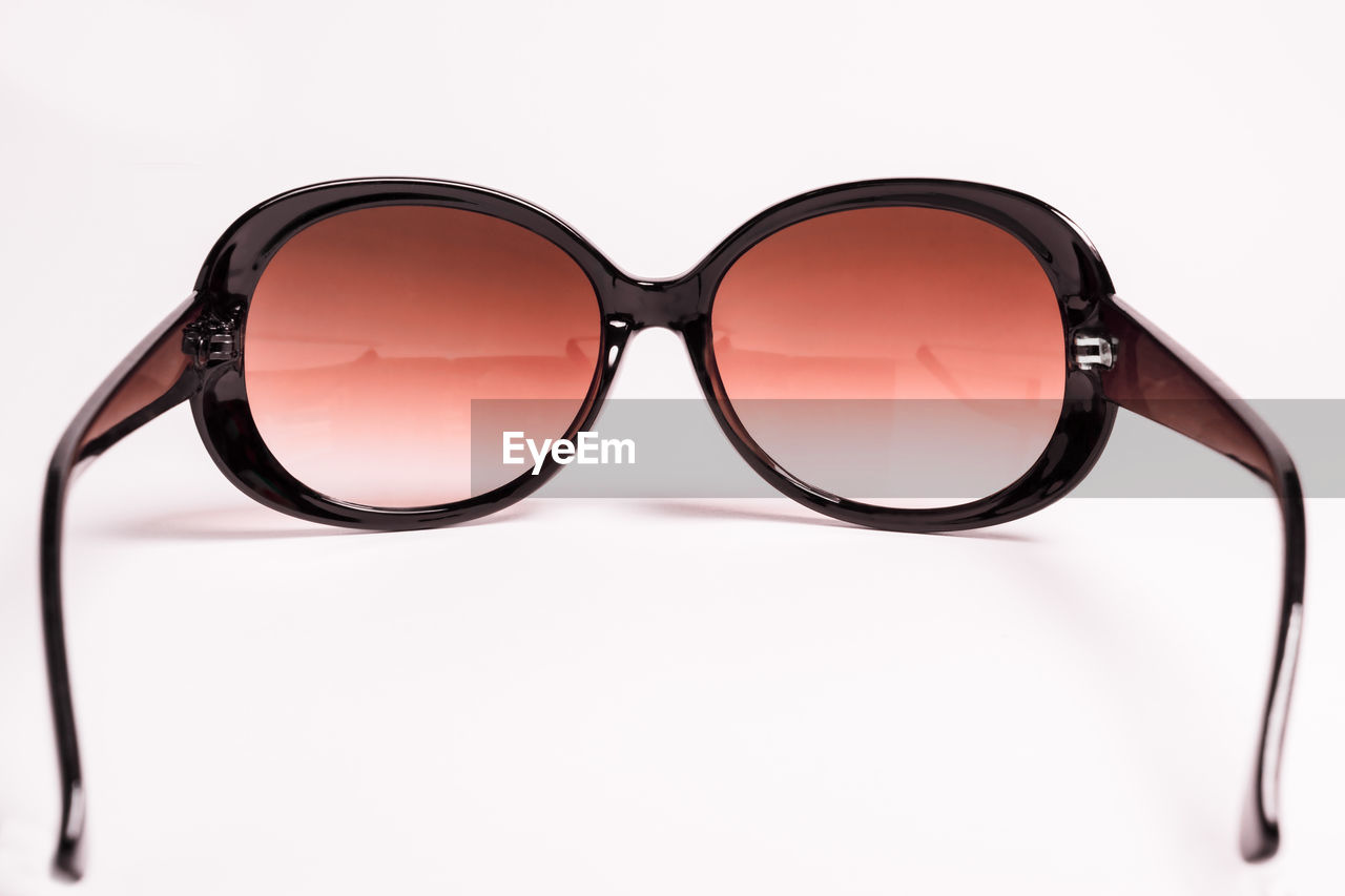 Close-up of sunglasses against white background