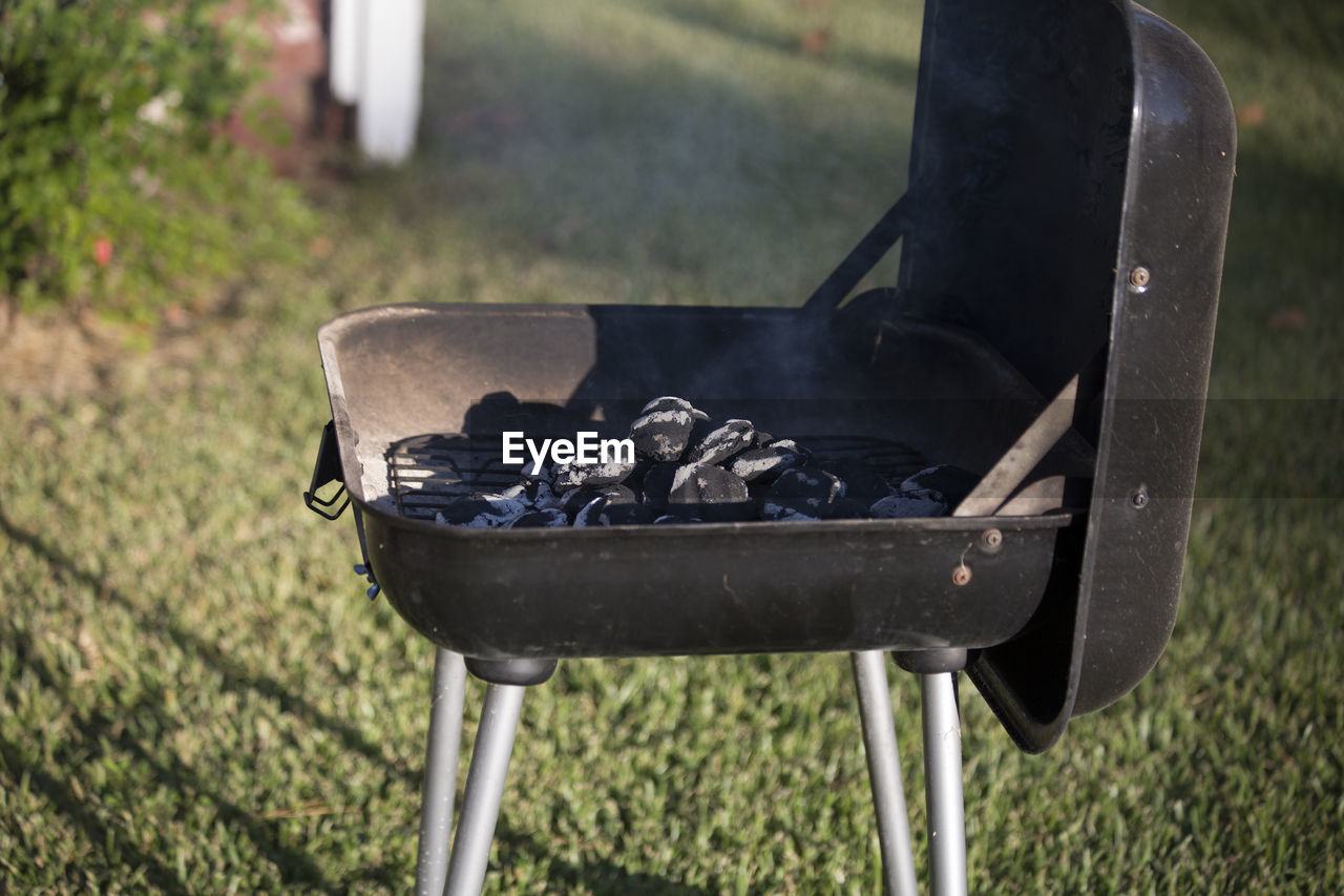 CLOSE-UP OF MEAT ON BARBECUE GRILL IN BACKYARD