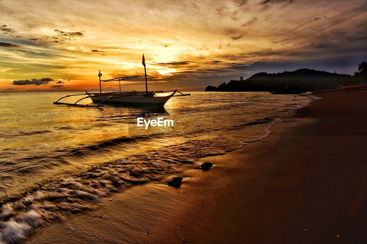 Scenic view of beach against sky during sunset