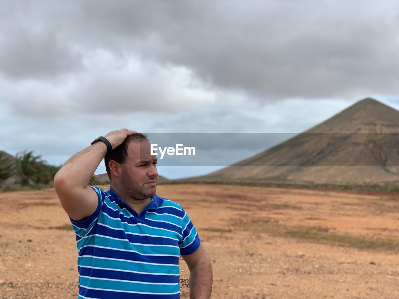 Man looking away against landscape and sky