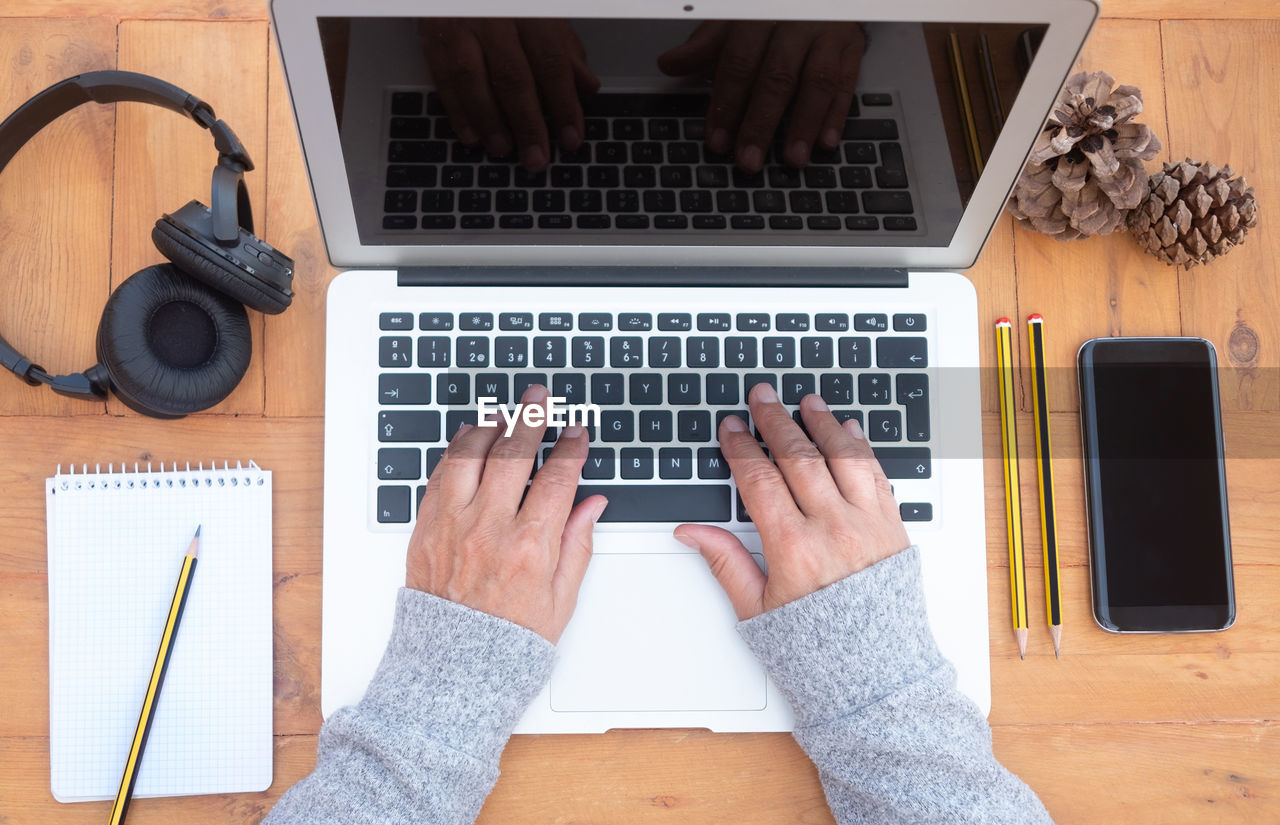 Directly above shot of person using laptop on table