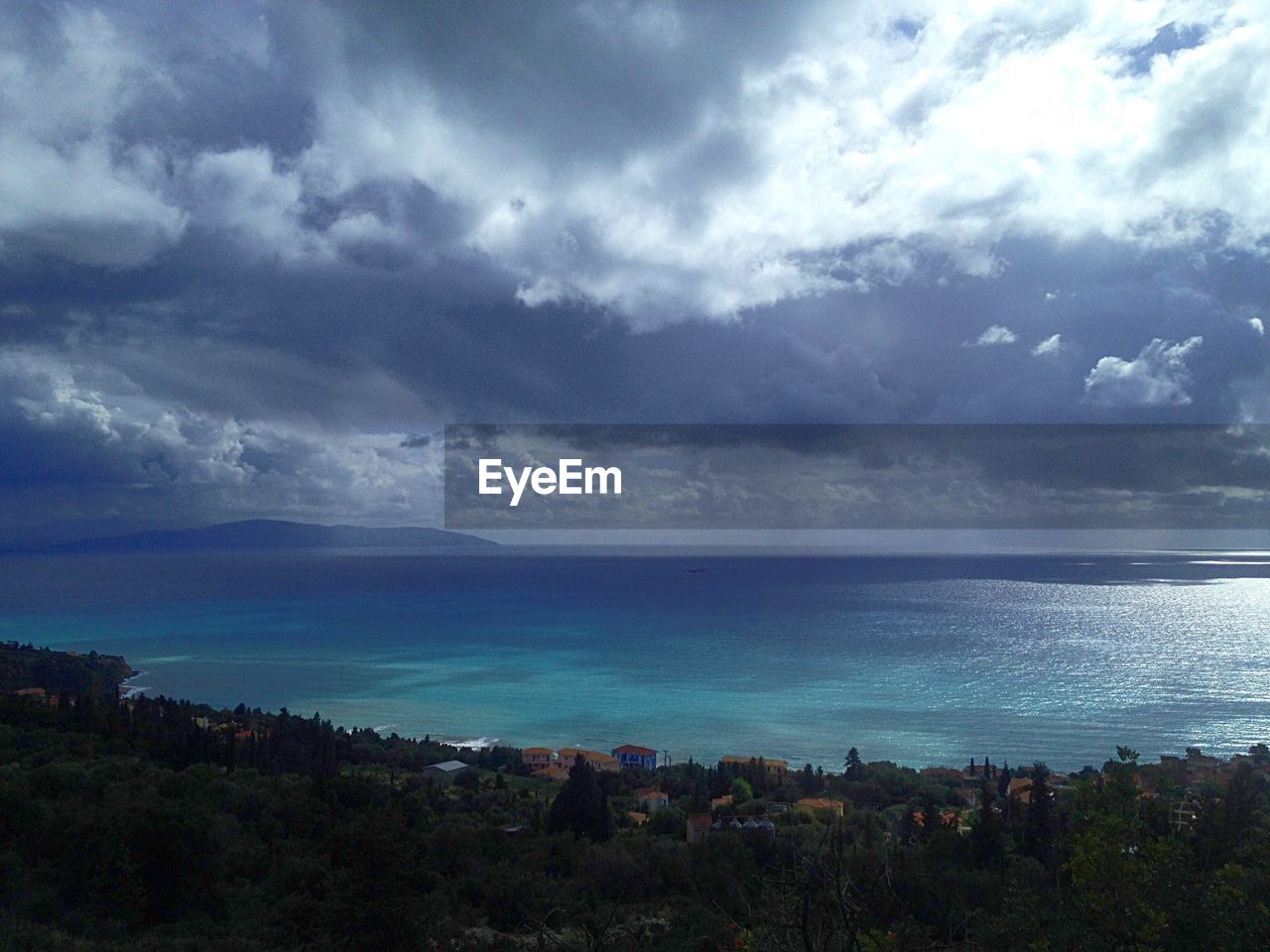 Scenic view of sea against cloudy sky