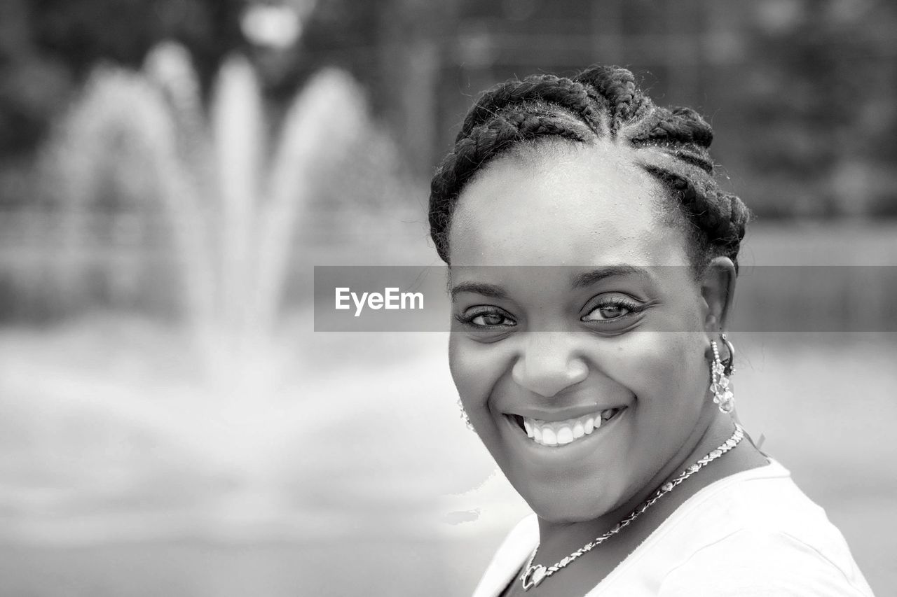 Close-up portrait of smiling young woman