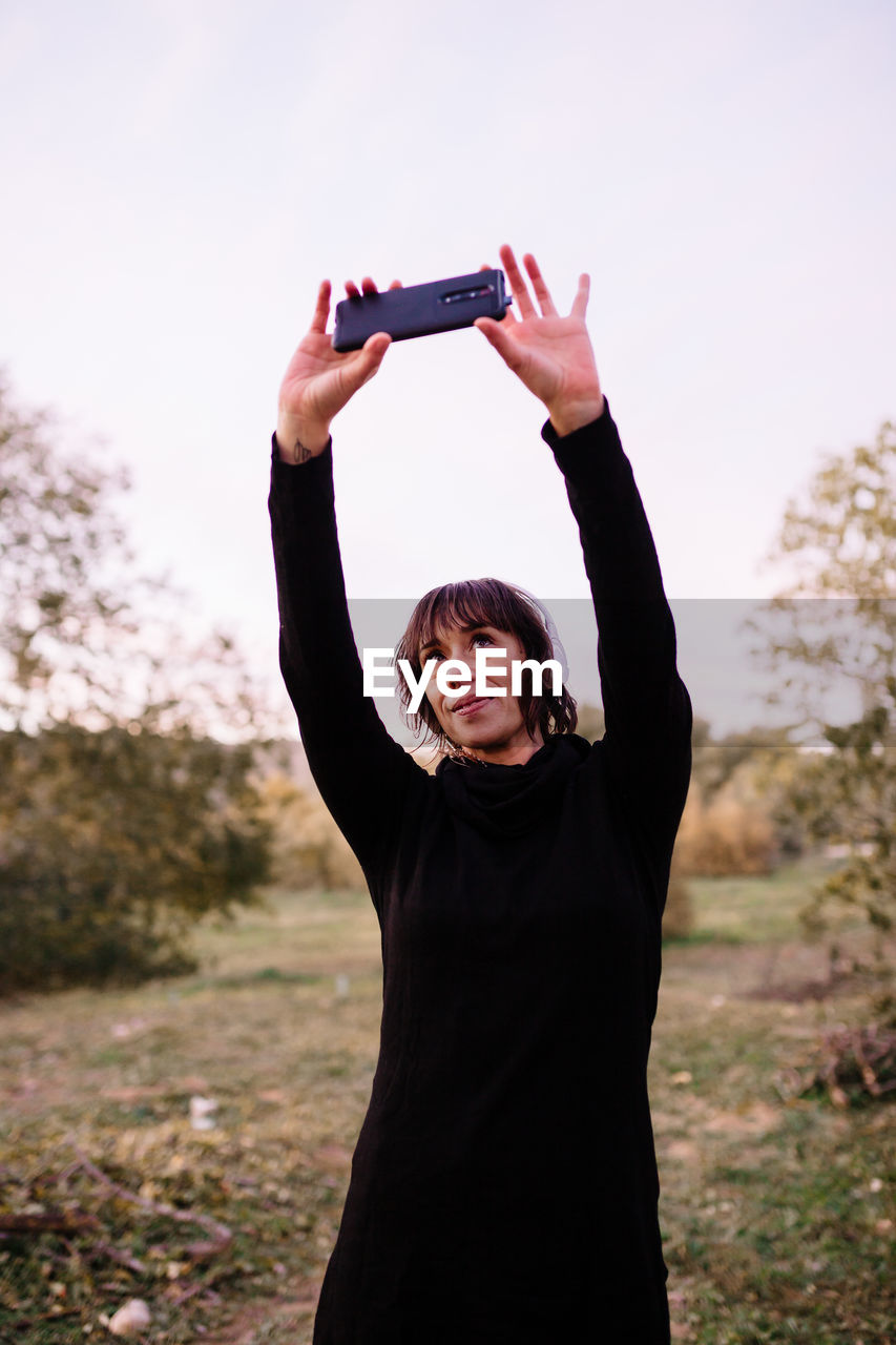 Woman doing selfie while standing at park