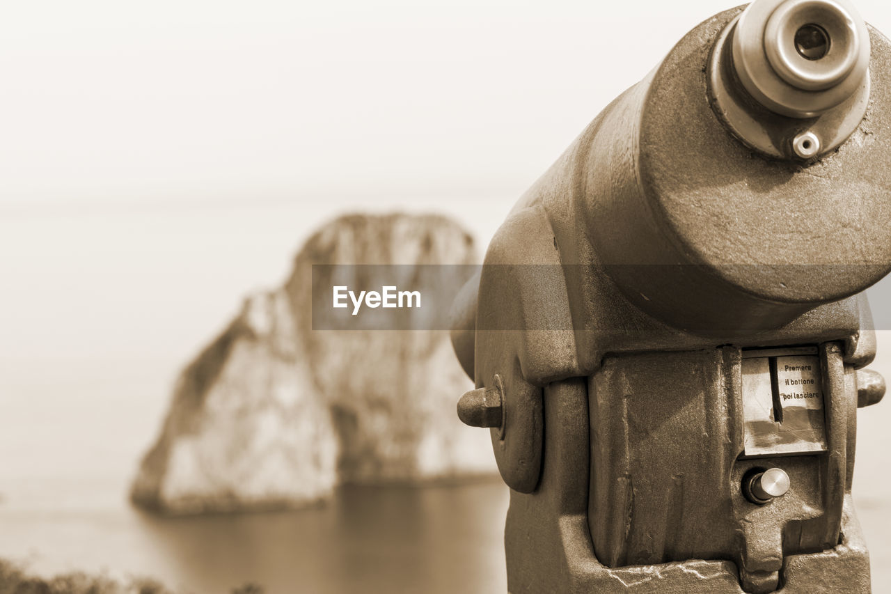 sea, water, beach, focus on foreground, land, nature, sky, binoculars, sculpture, sand, day, no people, camera, outdoors, security