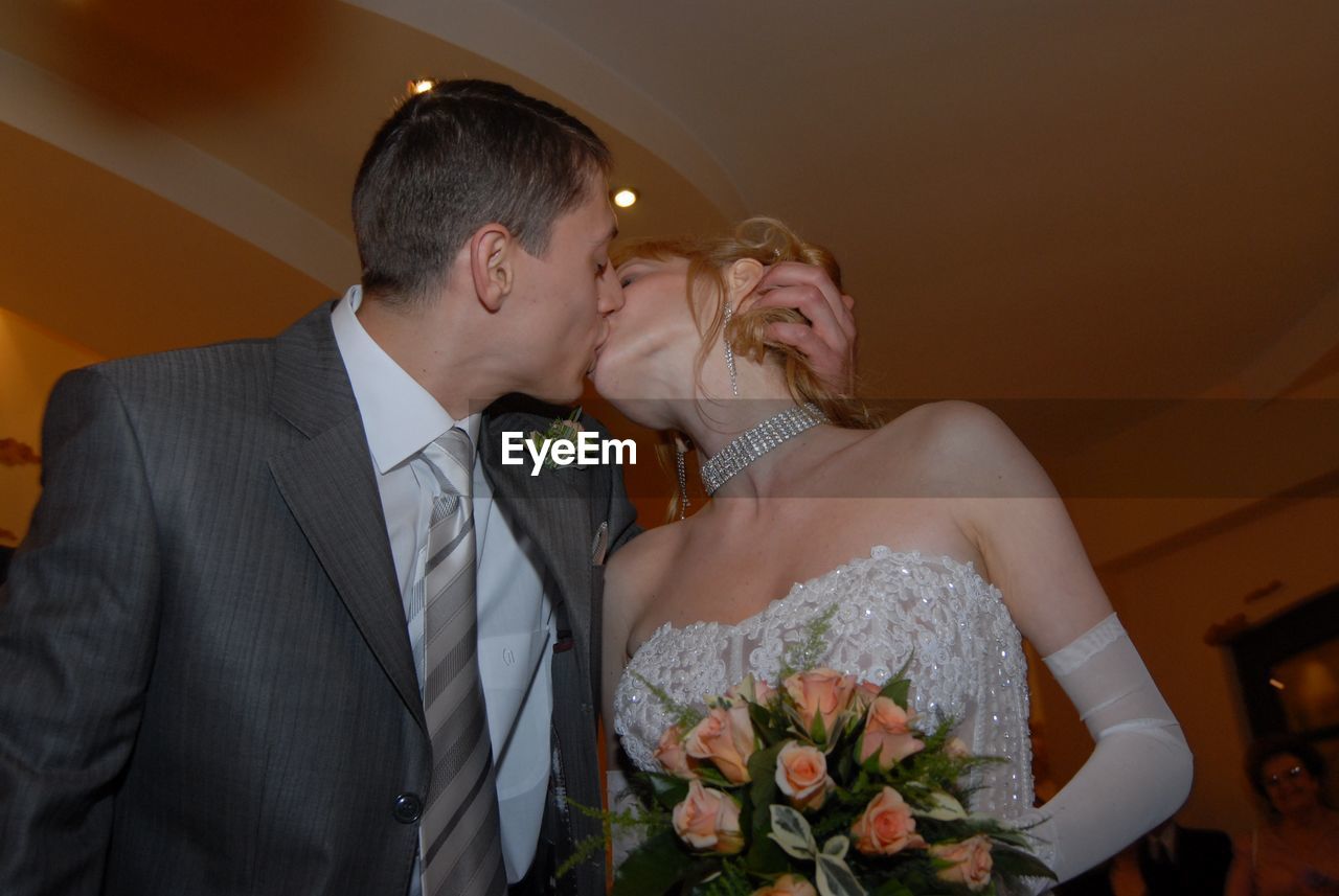 Couple kissing during wedding ceremony