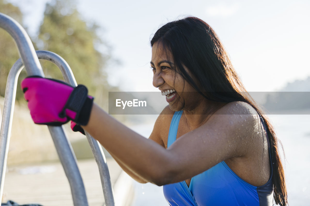 Woman preparing for swim at winter