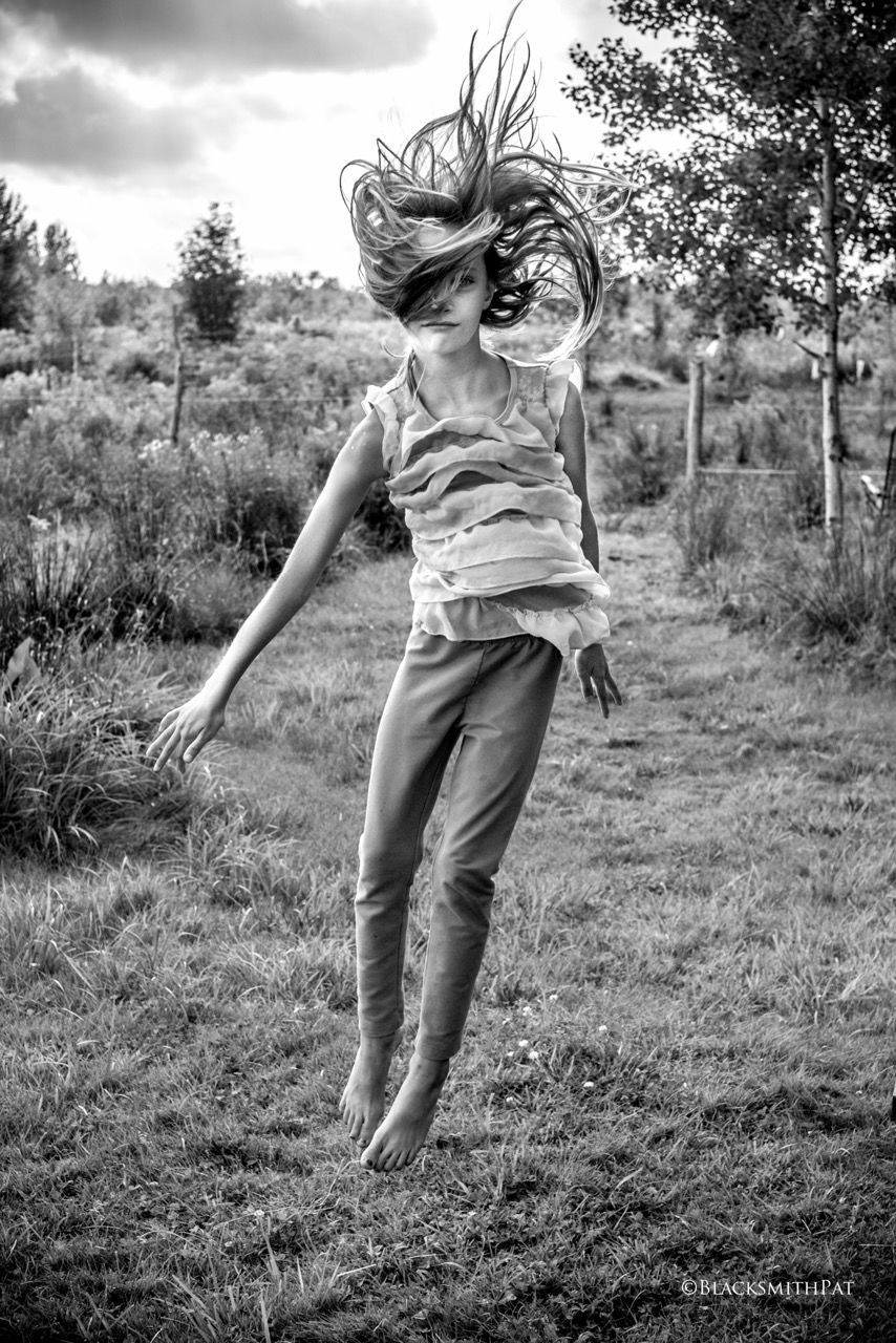 black and white, one person, plant, full length, monochrome photography, nature, monochrome, tree, white, land, child, casual clothing, grass, childhood, field, leisure activity, women, day, black, emotion, front view, lifestyles, female, outdoors, happiness, sky, portrait, carefree, environment, adult, smiling, landscape, fun, motion, jumping, clothing, young adult