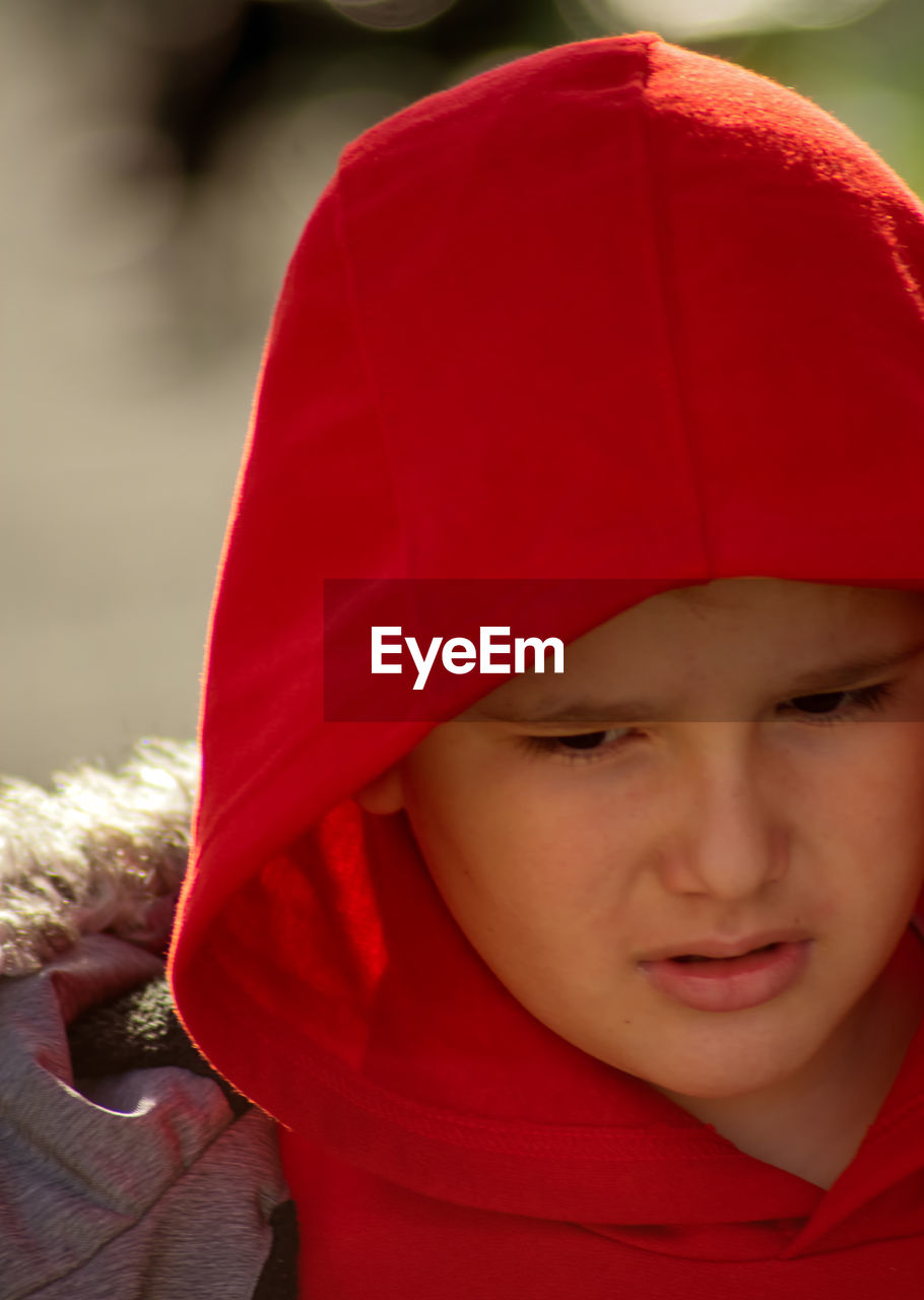 CLOSE-UP PORTRAIT OF BOY WITH RED EYES