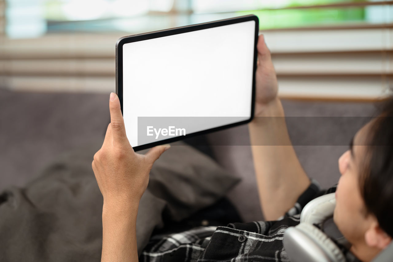 cropped hands of man using digital tablet