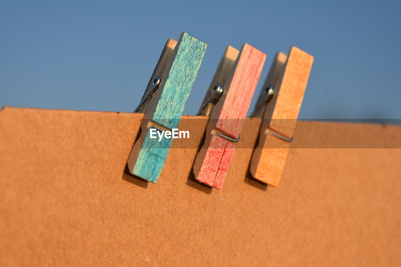 LOW ANGLE VIEW OF MULTI COLORED PENCILS AGAINST SKY