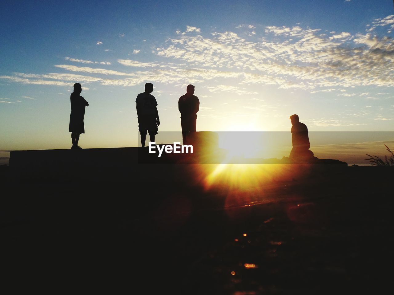 SILHOUETTE PEOPLE STANDING ON LANDSCAPE AT SUNSET