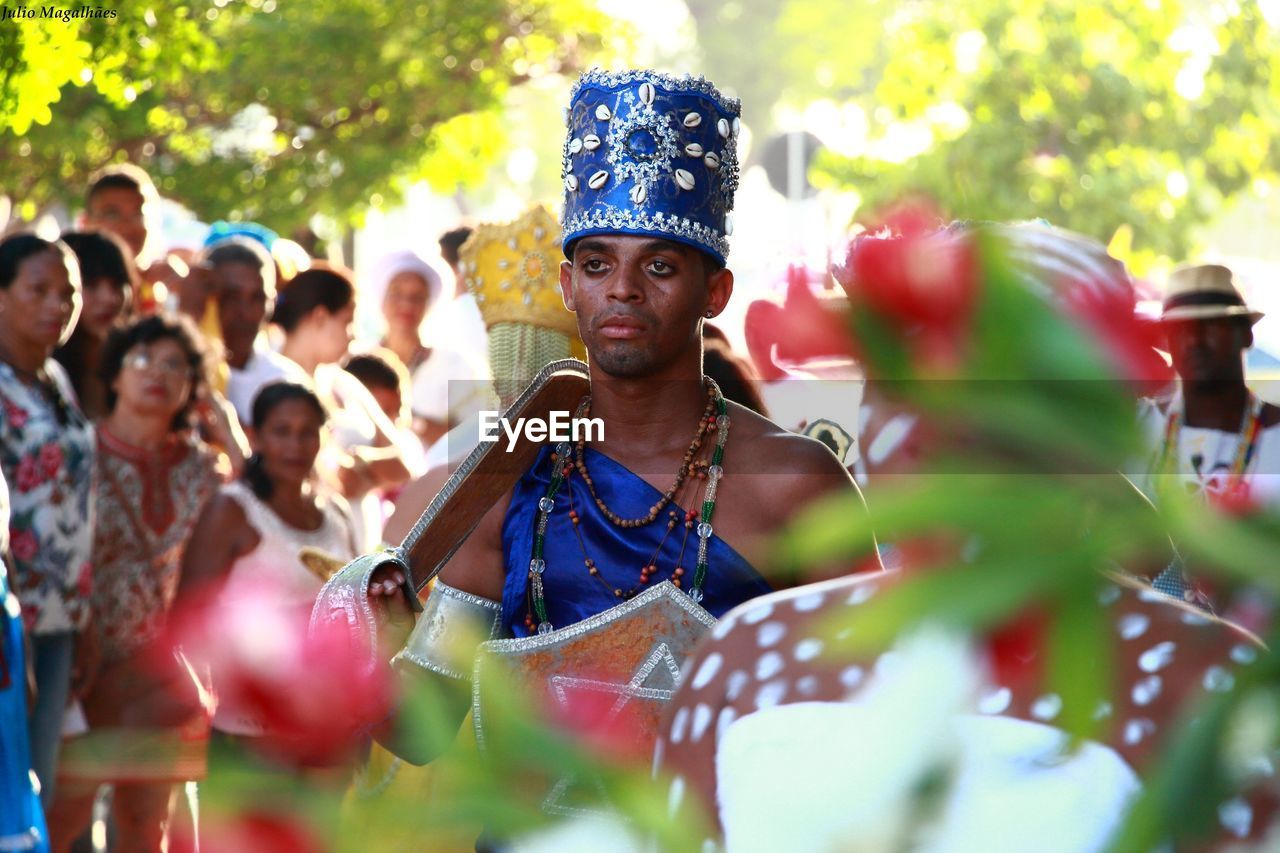 CLOSE-UP OF YOUNG WOMAN IN TRADITIONAL CLOTHING