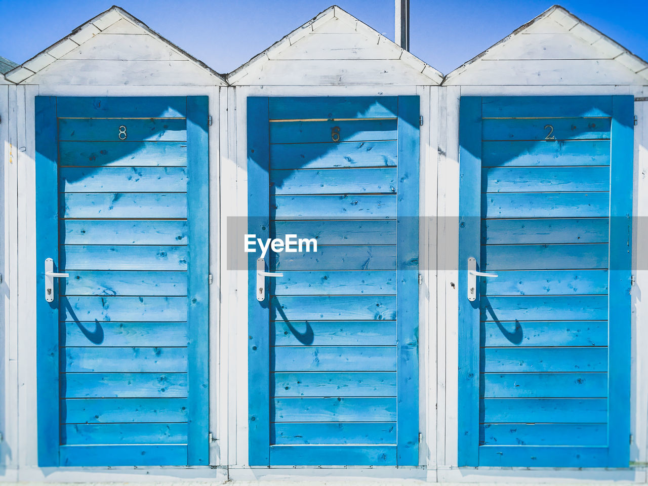 Closed doors of beach huts during sunny day