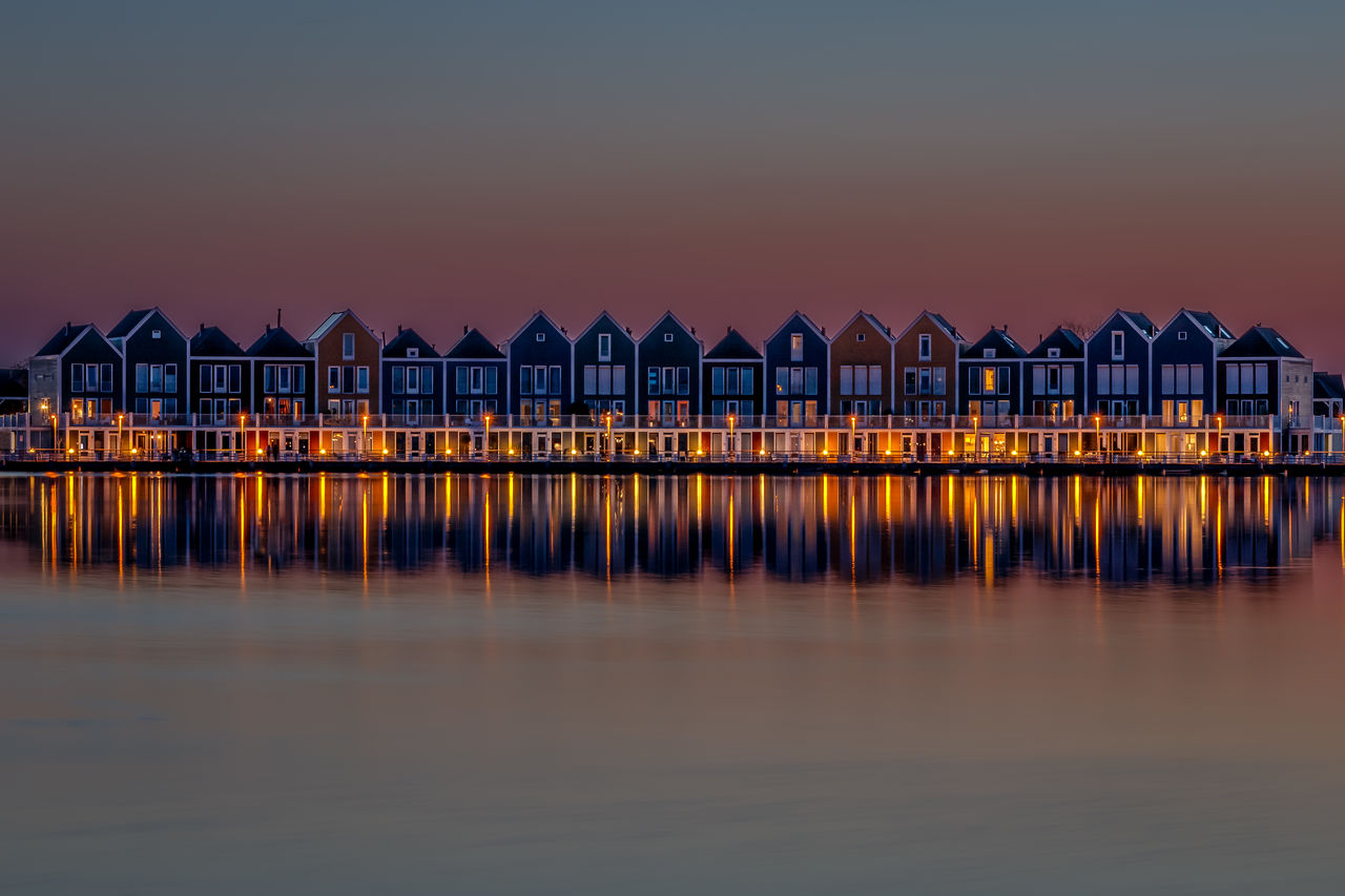 Rainbow wooden houses at sunset in houten, a little suburb of utrecht in south holland