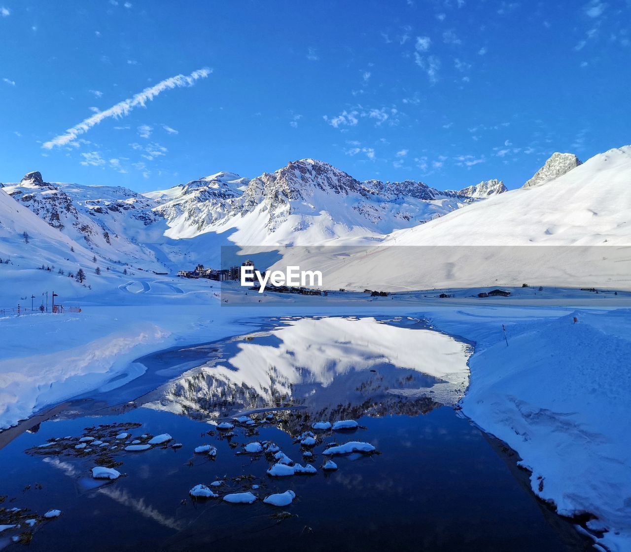 Scenic view of snowcapped mountains against blue sky