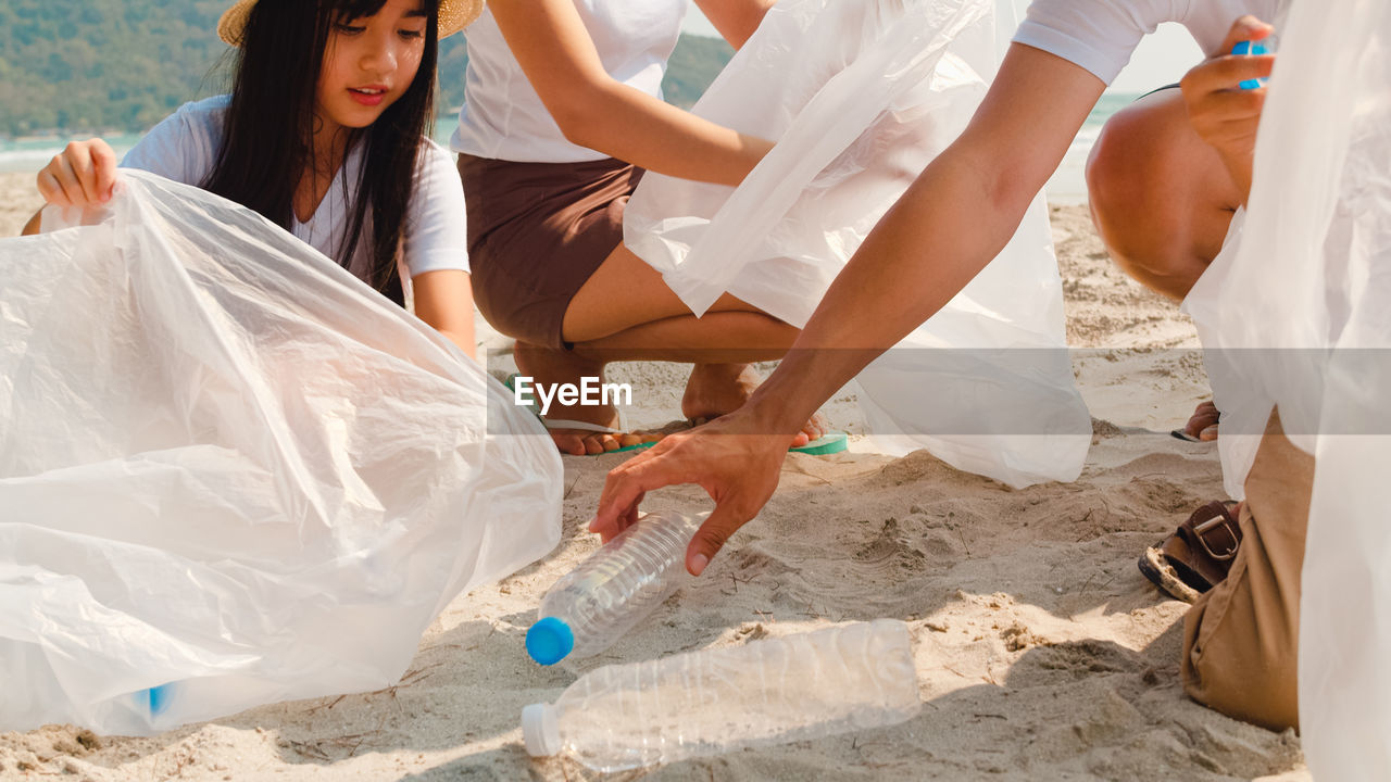 Family collecting garbage at beach