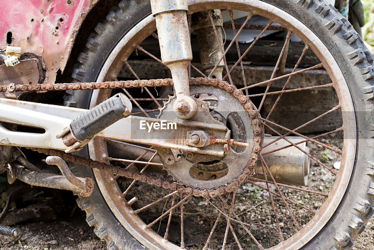 Close-up of rusty wheel on abandoned motorcycle