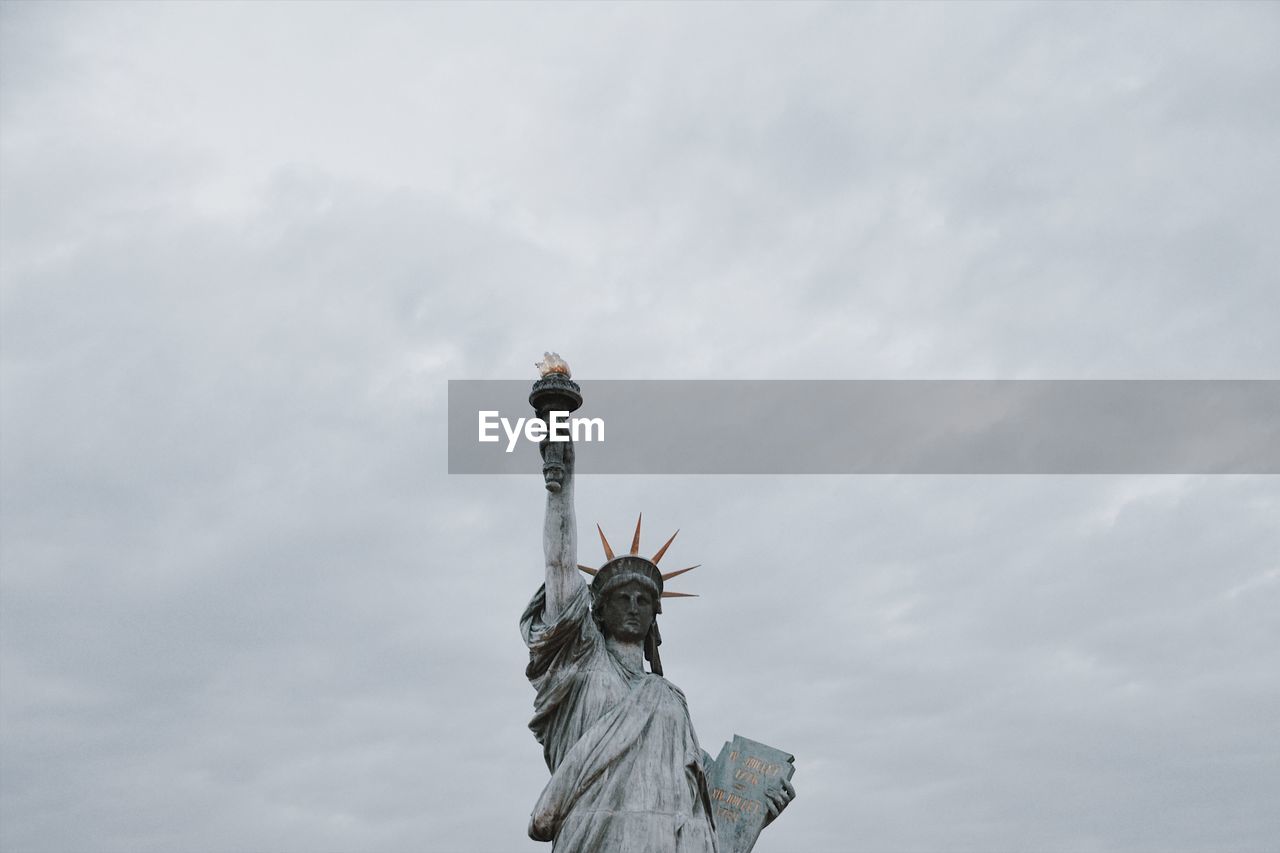 Low angle view of statue against cloudy sky