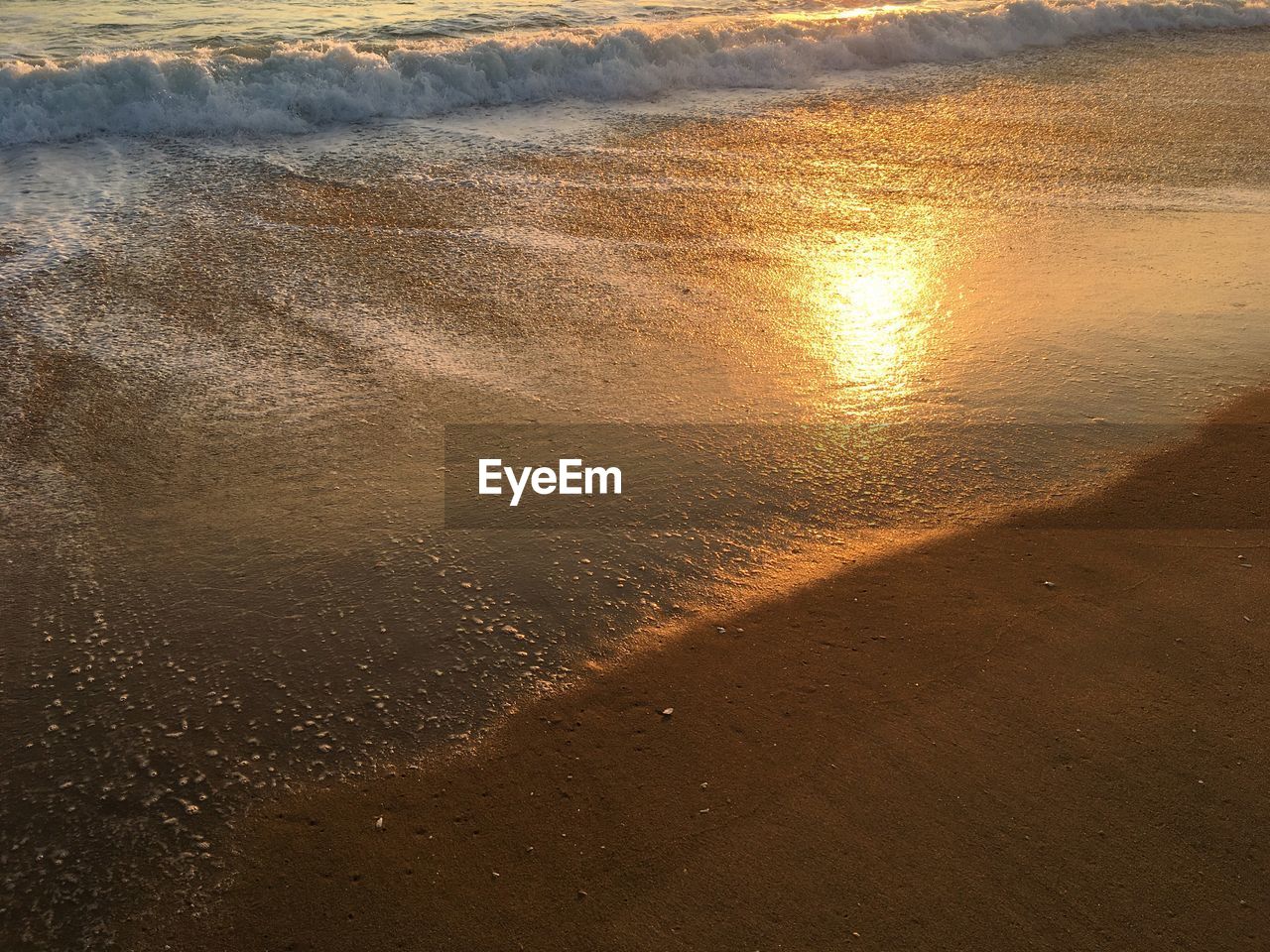 SCENIC VIEW OF BEACH DURING SUNSET